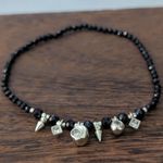 Thin Black Stretch Bracelet with Gold Tone Charms Photo 2