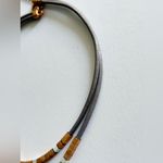 Set Saachi grey leather goldtone loop wrap bracelet and matching necklace. Gray Photo 6