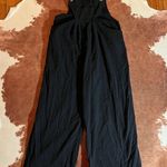 Boutique Black  wide leg jumpsuit  size XL zipper on side Does not fit a XL here are the actual measurements - Pit to pit - 18 inches  Inseam - 29 inches  Photo 0