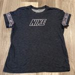 Nike women’s black/white Dri-Fit shirt with logo on sleeves size L Photo 0
