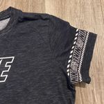 Nike women’s black/white Dri-Fit shirt with logo on sleeves size L Photo 2