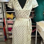 ZARA The dress in the image is a wrap style, with a geometric print of green circles Photo 1