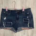LC Lauren Conrad Distressed Blue Jean Shorts with Floral Accents Photo 0