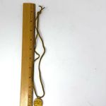 Mayan design gold tone pendant purchased in Costa Rica, on golden suede cord Photo 8