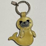Coach bag charm / keychain designed in the shape of a playful seal. Photo 0