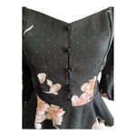 Allie Rose NWT- Beautiful black top with pink flowers, smocked back, 3/4 sleeves, ruffle bottom, brand new, size medium  Measurements: Bust: armpit to armpit 17-20 inches  Waist: side to side 14-16 inches  Length: shoulder seam to bottom 33 inches Photo 1