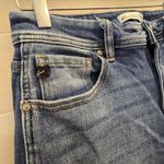 {29} KanCan Distressed Blue Jean Split Flare Hem Fringe Detail Photo 3