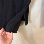 Lululemon black raw edge flowy top warm with small side slits Photo 3