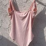 January 7  Medium light pink ruffle V body suit Photo 1