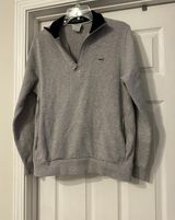 Lacoste long sleeve sweater is a Men's size Large. Photo 0