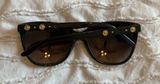 Versace | Stylish Black Sunglasses with Gold Accents Photo 0