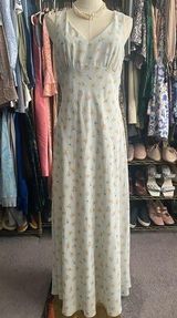 Long Dress: Elegant 90’s sleeveless dress features A-line silhouette, perfect for any occasion. The delicate fabric drapes beautifully, providing a flattering fit. This timeless piece can be dressed up or down, making it a versatile addition to your wardrobe. Ideal for summer gatherings or evening events, it's a must-have for style enthusiasts. Photo 0
