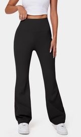 Halara High Waisted Back Pocket Plain Slight Flare Legging in Black Photo 0