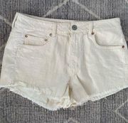 American Eagle size 12 Cutoffs Cream colored with Blue Flag on back pockets