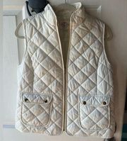 White puffer vest with gold accents