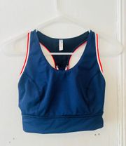 movement navy blue sports bra with red and white stripes size extra small