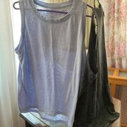 2 pack sleeveless tanks - unisex.One blue, one black