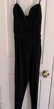 Woman’s black jumpsuit size medium with straps.