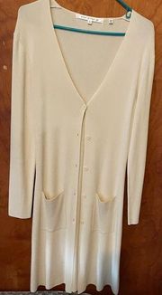 Long button up cardigan with long sleeves in a cream color