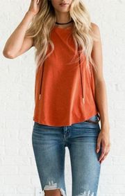 orange open back sleeveless top with drawstring detail 