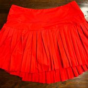 Red gold hinge pleated tennis skirt