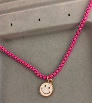 pink pop chain necklace with white smiley face charm