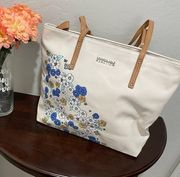 Kenneth Cole Reaction cream tote with blue and yellow flowers