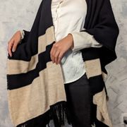 knitted black and beige fringed sweater poncho