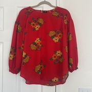 Lee red blouse with a yellow flower pattern.