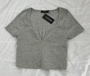 notch neck grey crop top  Size small Condition: NWT Color: grey Brand:  Details : -  Ribbed  - Stretchy  Extras:  - I ship between 1-2 days