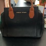 black leather purse with brown accents. Used good condition.