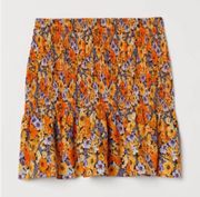 divided smocked orange floral mini skirt