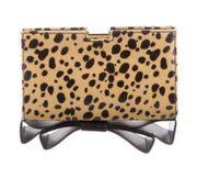 “Milla” Small Frame Animal Print Coated Clutch with Bow Accent Bottom