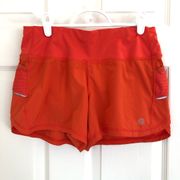 Athleta  Ready Set Go Orange Running Shorts with reflective details