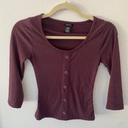 A maroon button down square collar neck line.