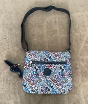 Kipling Crossbody purse. Floral print. With monkey keychain.