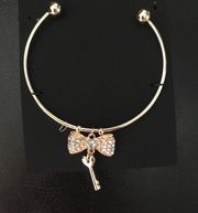 Guess pave gold bow and key bangle