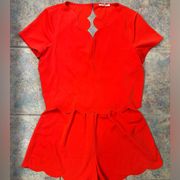 sugar + lips salmon colored scalloped romper with open back cutout