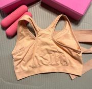 Light peach colored sport bra front zip size L