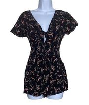 3/20$ Black tie front keyhole mini romper flower print with pockets size small