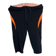 SAUCONY black and orange athletic leggings cropped size small EUC