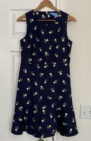 Draper James navy floral sleeveless dress with ruffled hem.