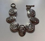 Silver look bracelet with silver swirls and a cool clasp