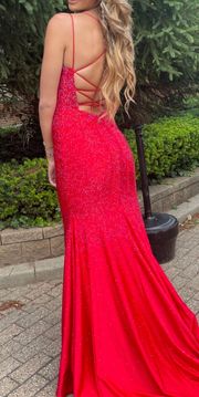 Sherri Hill Red Prom Dress Fitted rhinestone jersey gown with a V-Neckline and a lace up back.