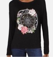 Floral print surrounds a graphic celestial wheel on this long sleeve tee