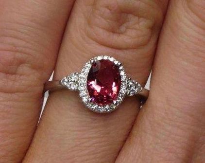 Oval Ruby and 1/4 CT. T.W. Diamond Sunburst Frame Ring in 14K White Gold |  Zales