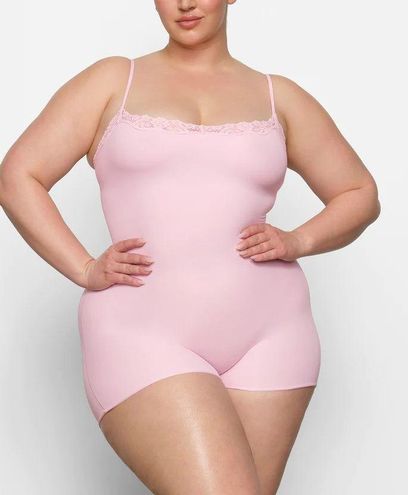 SKIMS, Cherry Blossom pink is your perfect excuse to get a new SKIMS  bodysuit. Kellee wears the Essential Scoop Neck Bodysuit, size 2X, in  Che