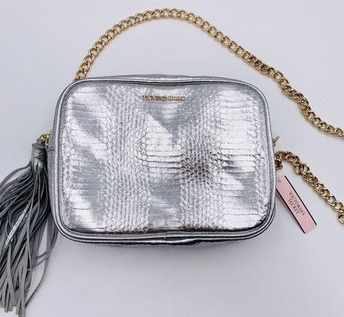 Buy the Victoria's Secret Silver Crossbody Clutch Bag with Gold Chain Strap  and Tassel Zipper Pull