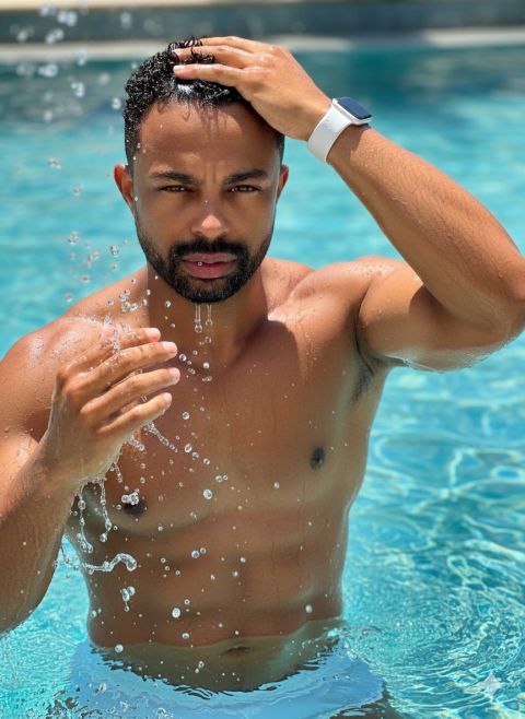 Ultra-realistic vertical portrait man waterfall rocks 8K