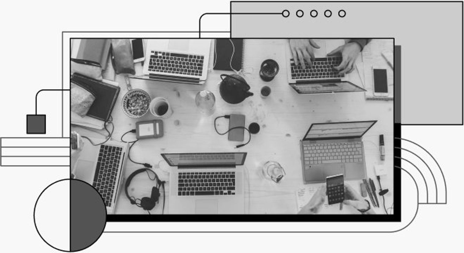 Photo of a desk with 4 people in their laptops.